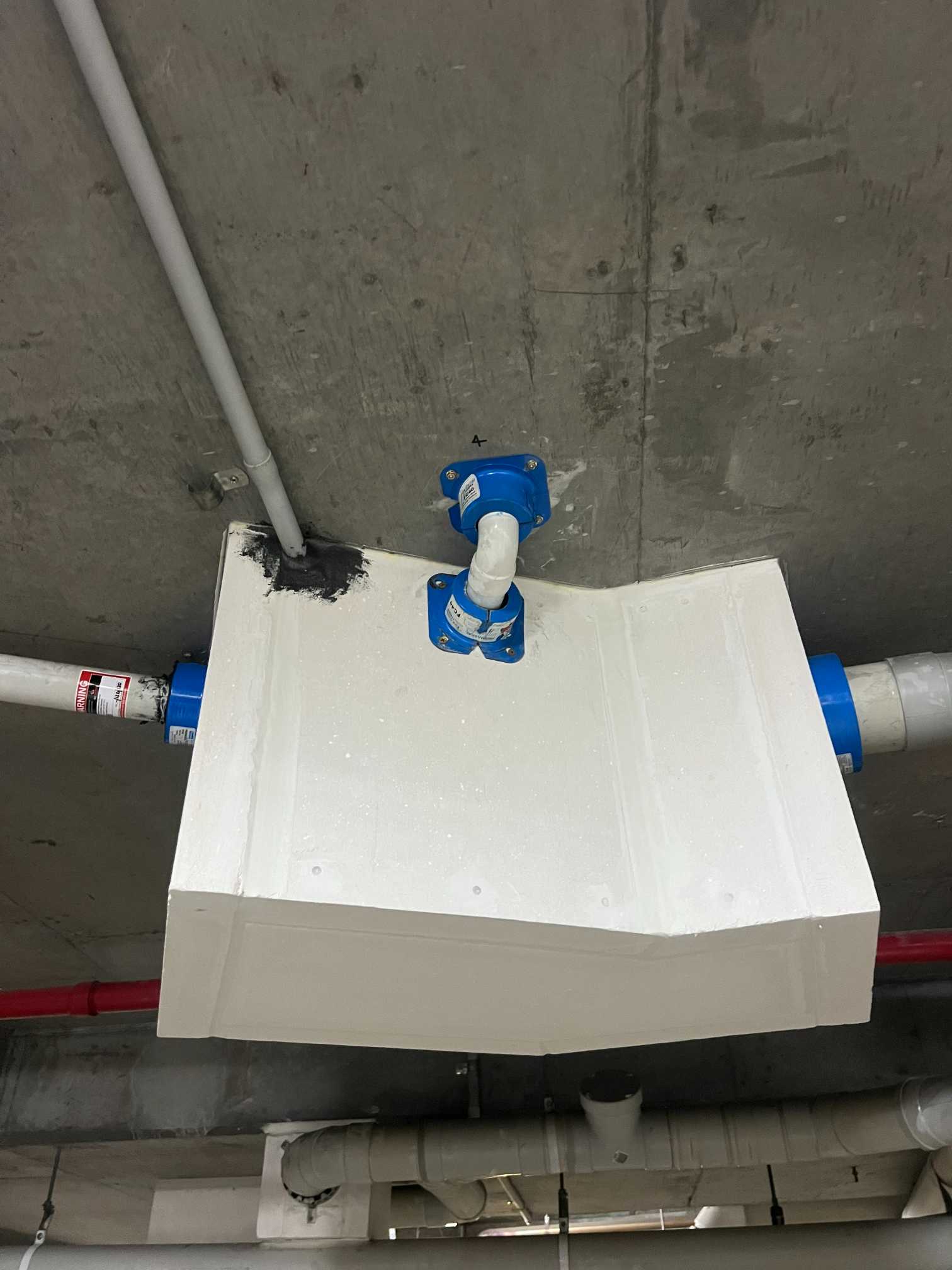 A White Box Connected to Blue Pipes, Designed for Fire Protection Systems — All Passive Services in West Gosford, NSW